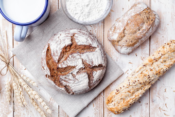 Delicious fresh bread on wooden background
