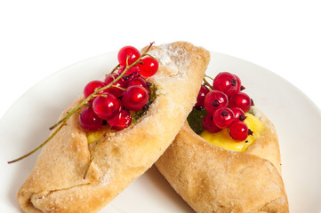 Bake isolated. Scones with jam on a plate. Pastry sprinkled with chocolate. Red currant.