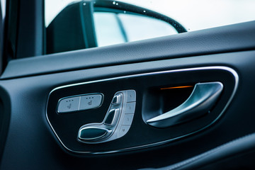 Luxury car interior. Door, seat and window controls