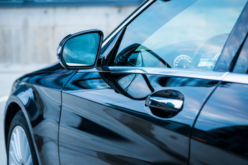 Closeup shot of black modern car's side mirror
