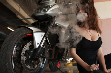 Obraz na płótnie Canvas Elegant woman smoking e-cigarette with smoke