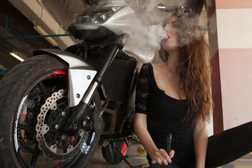 Plakat Elegant woman smoking e-cigarette with smoke