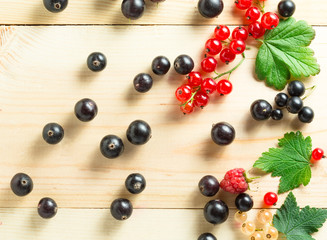 border of fresh berries mix on wooden tabletop