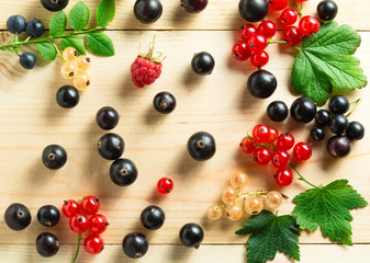 Naklejka na ściany i meble border of fresh berries mix on wooden tabletop