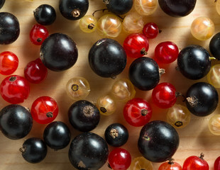 border of fresh berries mix on wooden tabletop