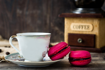 Coffee cup, macaroons and coffee grinder


