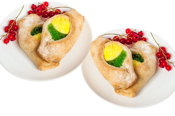 Bake isolated. Scones with jam on a plate. Pastry sprinkled with chocolate. Red currant.