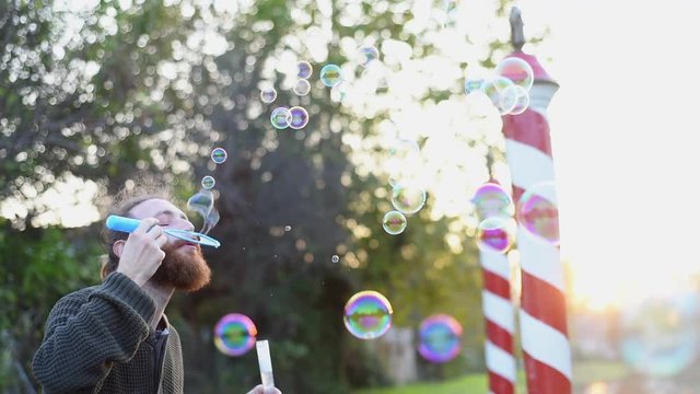 Blowing bubbles at sunset