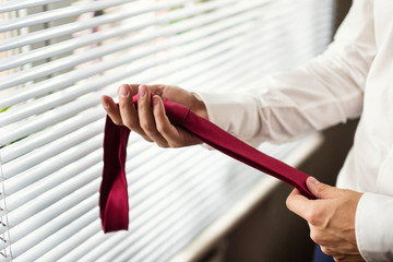 man holding his tie in his hand