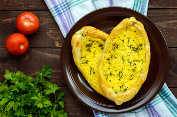 Khachapuri in Adjara (flat cakes with different fillings in the form of a boat) - the national dish of Georgian cuisine. The top view