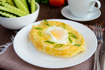 Khachapuri in Adjara (flat cakes with different fillings in the form of a boat) - the national dish of Georgian cuisine.