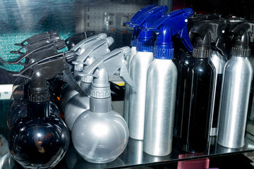Row of long and globe-shaped spray bottles.