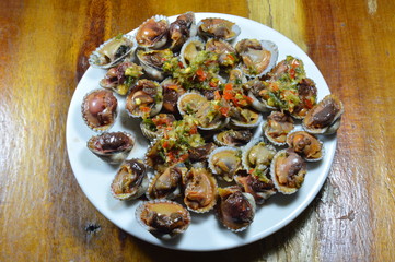 steamed cockle dressing spicy sauce on plate