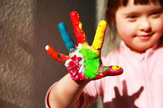 Cute little girl with painted hand