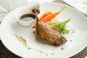 Roast duck leg cuisine serve with sauce fresh and vegetable