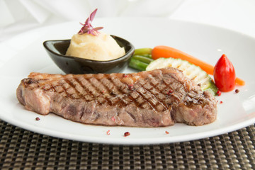 beef steak  , asparagus, and red carrot garnish.