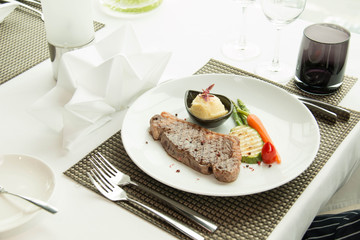 beef steak  and red carrot garnish.