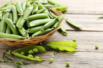 Green peas on a grey wooden table