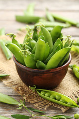 Green peas on a grey wooden table