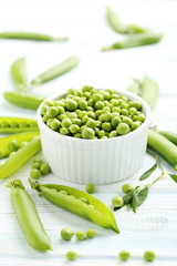 Green peas on a blue wooden table