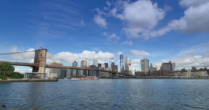 A wide angle view of the New York Skyline and the Brooklyn Bridge as seen from Brooklyn.  	