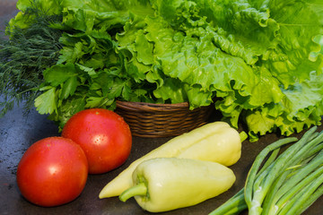 Tomatoes, yellow pepper and onion shallots on a background of gr