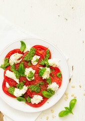 Delicious salad of tomato, mozzarella and pesto.