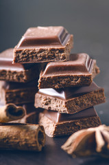 Two chocolate buildings on a dark background. energy and sugar. Broken bar. Chocolate blocks stack 
