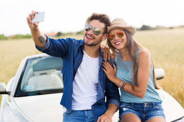 Couple taking a selfie while out on a road trip
