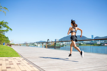 Back view of woman running in a city