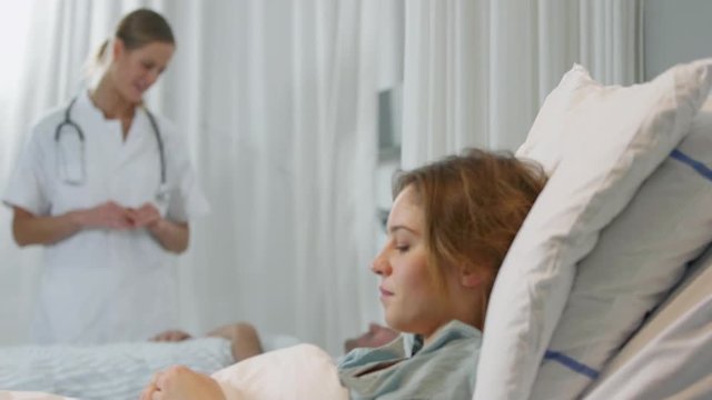 Doctor and patients in hospital ward