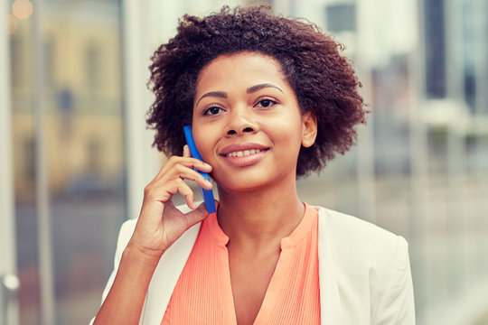 happy african businesswoman calling on smartphone