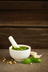 Homemade pesto in a white marble mortar.