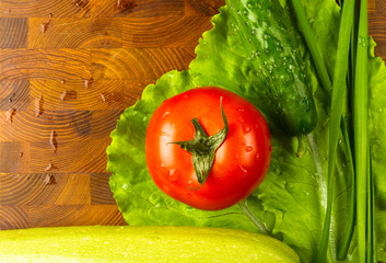 stilllife - tomatoes, cucumbers, green garlic and lettuce