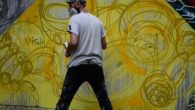 Process of creation of graffiti, fence.