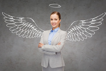 happy businesswoman with angel wings and nimbus