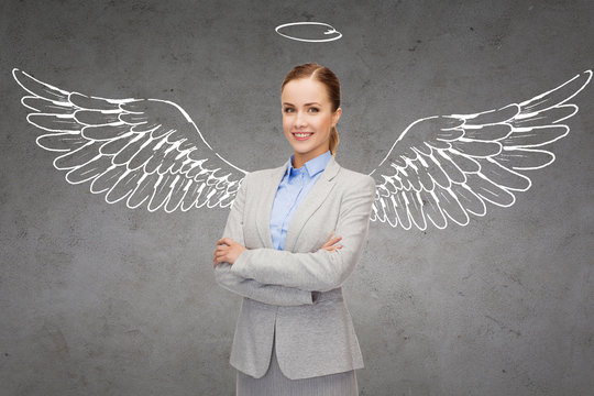 happy businesswoman with angel wings and nimbus