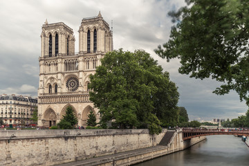 Fototapeta na wymiar Notre Dame de Paris. France. Ancient catholic cathedral on the quay of a river Seine. Famous touristic architecture landmark in summer