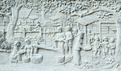 Stone carving of Traditional Thai culture on temple wall
