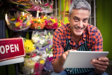 Male florist using digital tablet