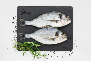 Fresh dorado fish on slate cutting board.Top view, copy space.