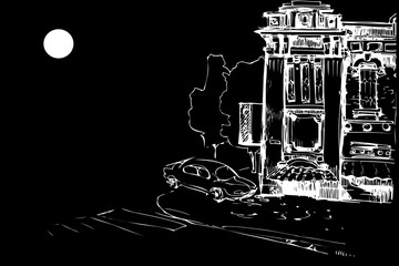 facade of the old house and the car at night