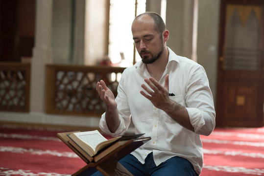 Man sitting in mosque praying