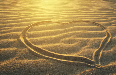 drawing a heart on the sea beach