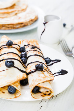 Pancakes with fresh blueberries and chocolate sauce