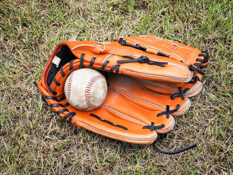Nostalgic baseball in glove on a baseball field, Close up image
