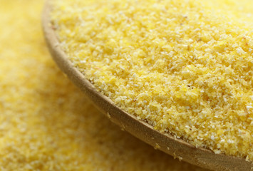 macro shot corn flour in a wooden spoon, soft focus © Olga Kriger