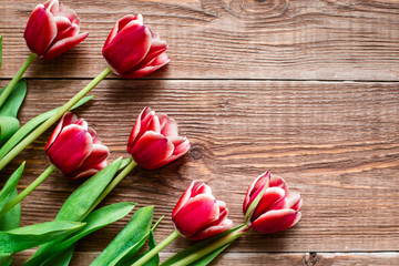 Red tulips. Flowers on wooden background. Copy spase.