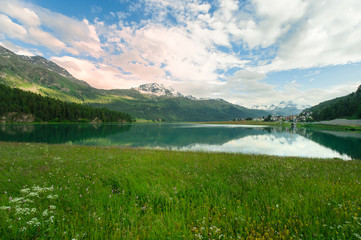 view of a mountain lake in Engadin valley in the summer time