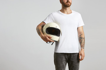 Attractive brutal tattooed bearded guy poses in black jeans and blank white t-shirt from premium...